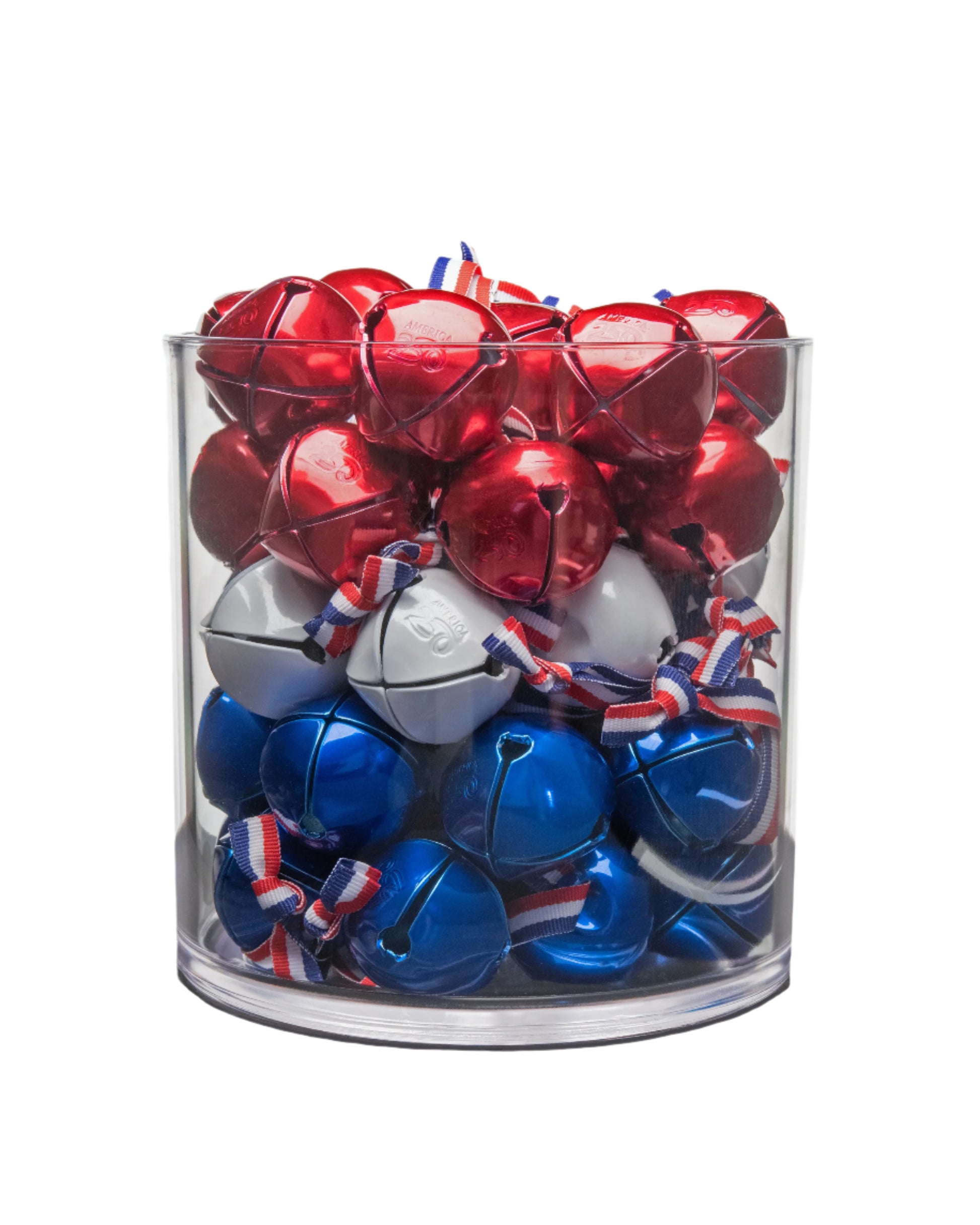 Clear glass container filled with red, white, and blue jingle bells on a white background