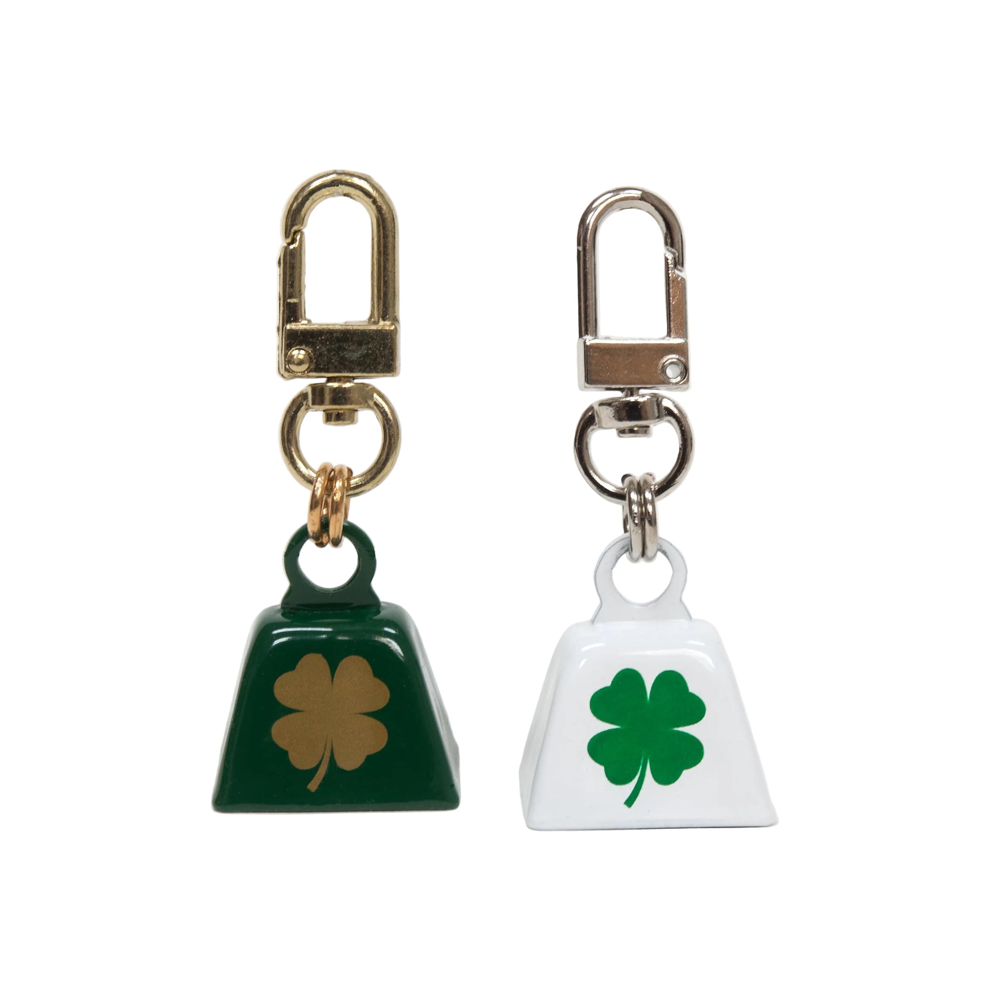 Two keychains with clover designs on a white background